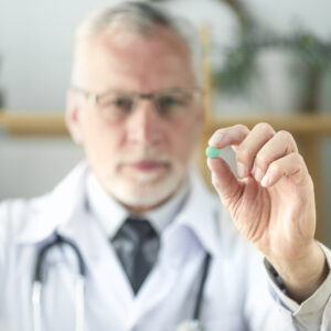 Blurred doctor showing medicine